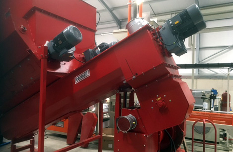 Twin discharge auger feeding hammer mill